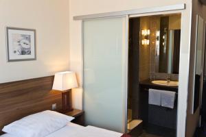 Ein Bett oder Betten in einem Zimmer der Unterkunft Ivbergs Hotel Berlin Messe