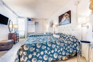 1 dormitorio con 1 cama con edredón azul y blanco en Pyramid VI, en Ocean City