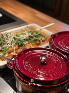 two red plates on a table with a tray of food at Gästisbacken in Alfta