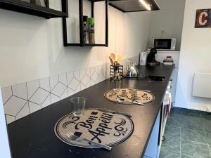 a kitchen with two signs on a counter top at L'Atelier - T1 près de la gare de Mulhouse in Mulhouse