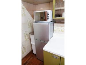 a small kitchen with a refrigerator and a microwave at THE TORII - Vacation STAY 68438v in Kumamoto