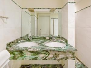 two sinks in a bathroom with a marble counter top at City Centre Rooms and Apartments in Verona