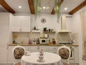 a kitchen with a table and two chairs and a microwave at The Hedgehog Boutique House & Garden in Cluj-Napoca