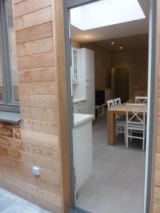 a sliding door leading into a kitchen and dining room at Aimée in Ypres +20 photos