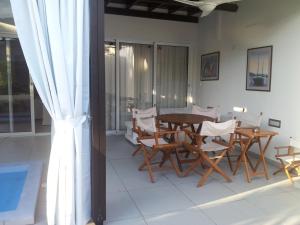 a dining room with a table and chairs at Yialos Holiday Apartments in Perivolia