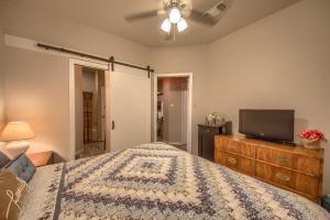a bedroom with a bed and a flat screen tv at SS 4B Riverside Condo in New Braunfels