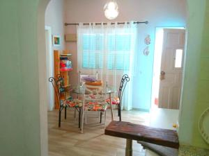 a dining room with a glass table and chairs at Casa Trini in La Mareta