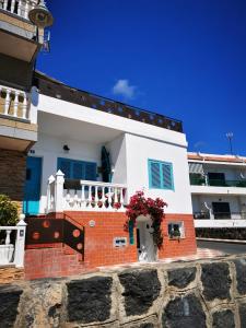 a white and red brick house with a balcony at Casa Trini in La Mareta