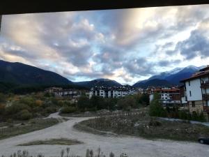 a road in a town with mountains in the background at BANSKO WINSLOW INFINITY - Studio in Bansko
