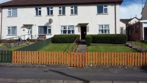 a white house with a fence in front of it at Riverview House in Enniskillen