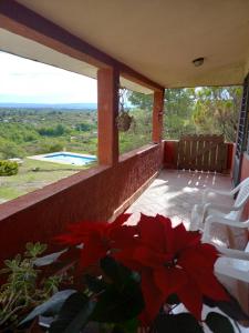 a porch with chairs and a view of a pool at MIRADOR DEL LAGO - La Vista in Villa Parque Siquiman
