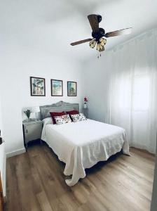 um quarto com uma cama e uma ventoinha de tecto em Casa Rural La abuela em El Campo
