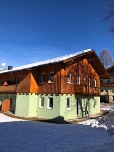 a building with a wooden roof on top of it at Apartment Heijerhof - Top 6 in Wagrain