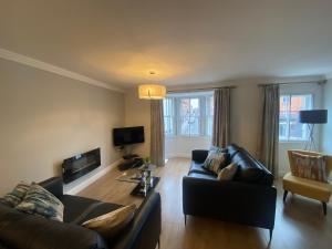a living room with a couch and a table at GS - Luxury, modern town centre, 2 beds, free parking for one vehicle in Stratford-upon-Avon