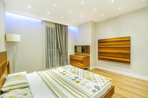 a bedroom with a large bed and a television at Baku Fantastic Port Baku Residance in Baku