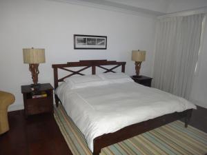 a bedroom with a bed and two nightstands and two lamps at The Atlantis Historic Inn in Saint Joseph