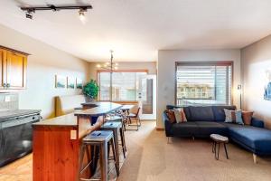 a kitchen and living room with a couch and a table at Bears Paw 5 in Big White
