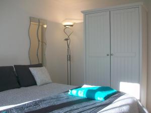 a bedroom with a bed and a floor lamp at Number 8 in Bury Saint Edmunds