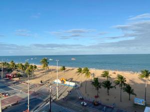 a view of a beach with palm trees and the ocean at Um sonho à beira mar in João Pessoa