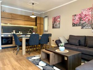 a living room with a couch and a table at EKA Luxury Two-Bedroom Premium Apartment in Durrës +46 photos