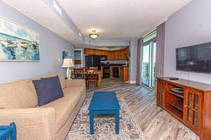 a living room with a couch and a flat screen tv at Bay View Resort Unit 1711 in Myrtle Beach