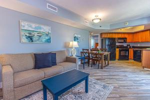 a living room with a couch and a table and a kitchen at Bay View Resort Unit 1711 in Myrtle Beach