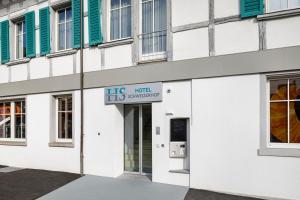 a building with a sign that reads his hot supermarket at Hotel Schweizerhof in Wetzikon