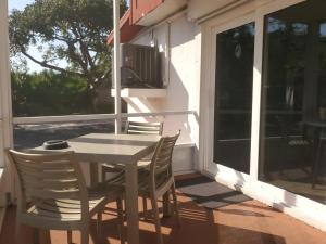 a table and chairs on a porch with a window at Ragged Edge Resort & Marina in Islamorada