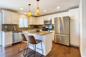 a kitchen with white cabinets and stainless steel appliances at Boho Paradise Valley with Pool Near Scottsdale! in Phoenix
