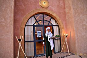 a statue of a woman standing in front of a window at Sunrise Palace Merzouga in Merzouga