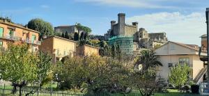 a group of buildings in front of a castle at Casa Al Lago in Bolsena