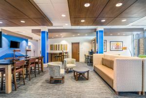 a lobby with a couch and tables and chairs at Holiday Inn Express & Suites - Asheboro, an IHG Hotel in Asheboro