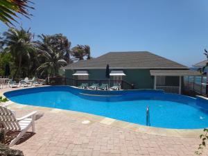 a swimming pool in front of a house at The Atlantis Historic Inn in Saint Joseph