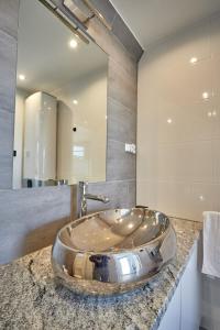 a bathroom with a sink and a large mirror at Domek na Roztoczu Sauna & Jacuzzi in Horyniec