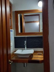 a bathroom with a sink and a mirror at Casa Lewana in Villa de Leyva