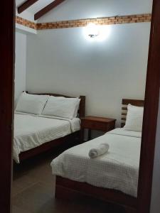 a room with two beds at Casa Lewana in Villa de Leyva