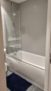 a bathroom with a shower and a white tub at B90 Contractor & Family Stays Near NEC BHM Airport in Hockley Heath