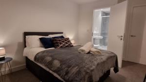 a bedroom with a bed with two shoes on it at B90 Contractor & Family Stays Near NEC BHM Airport in Hockley Heath