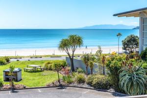 a view of the beach from a house at The Sands - Apartment 26 - Stay Waiheke in Onetangi