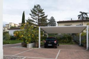 a car parked in a parking lot in front of a house at Casa Alina- Art House in Foligno