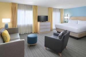 a hotel room with a bed and a tv at Sonesta ES Suites Houston - NASA Clear Lake in Webster