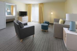 a hotel room with a couch and a bed at Sonesta ES Suites Houston - NASA Clear Lake in Webster