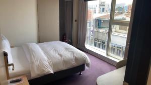 Postel nebo postele na pokoji v ubytování Michi Hotel - Luodong