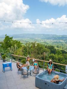 a group of people sitting around a hot tub on a patio at Hacienda Piloto 108 in Mayaguez