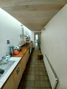 a kitchen with a counter top and a long hallway at Hotel Nativo in Santiago