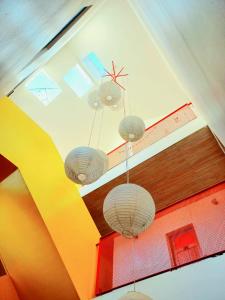 three chandeliers hanging from a ceiling in a room at Hotel Nativo in Santiago