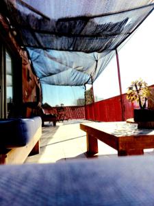 awning over a table and bench on a balcony at Hotel Nativo in Santiago