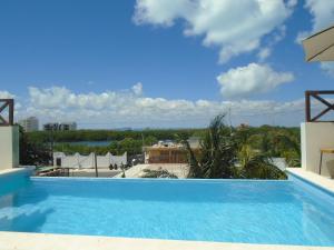 a view of a swimming pool from a building at Casa Linda Isla Loft- Ocean View- Shared Pool in Isla Mujeres
