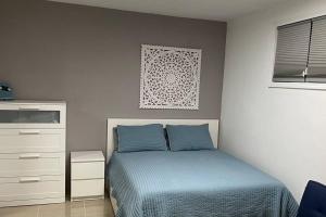 a bedroom with a bed and a dresser at California Apartments in Yabucoa
