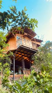 a tree house with a balcony in the middle at Tropical House in La Vega